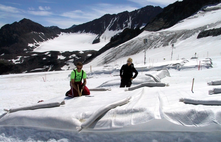 Innsbruck University researchers check part of the glacier at Austria's Stubai resort in this July 4, 2005, file photo. That section had been covered with white polyethylene to help protect the glacier from the sun.