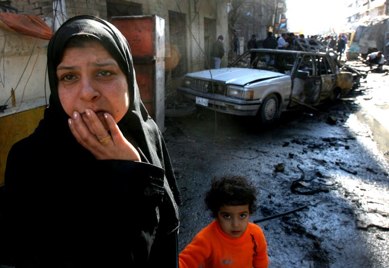 A woman reacts at the scene of a car bomb blast in the predominantly Shiite commercial district of Karradah in downtown Baghdad, Iraq, Tuesday Jan. 23, 2007. Four people, including a woman and a 7-year-old boy, were killed and seven others were wounded, police said. (AP Photo/Khalid Mohammed )