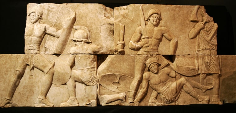 Ancient Roman marble reliefs depicting gladiators in combat are presented to the press on Wednesday, after their recovery from the garden of a private home north of Rome.