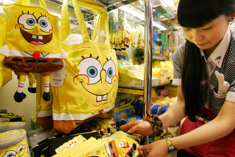 Kiddy Land toy store sales clerk Juri Igarashi arranges SpongeBob goods in Tokyo. More than 30 companies in Japan are churning out goods with his likeness.