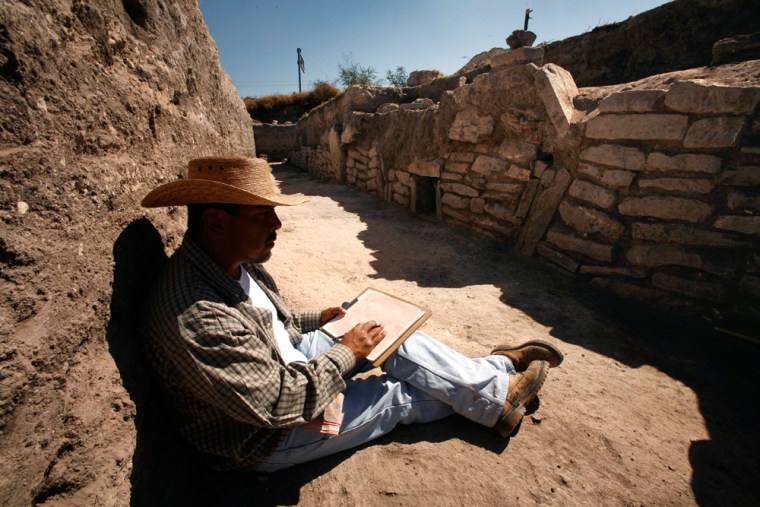 An unidentified archeologist draws the patterns of the stones found at the recently discovered Zazacatla archeological site near the town of Xochitepec, Mexico. 