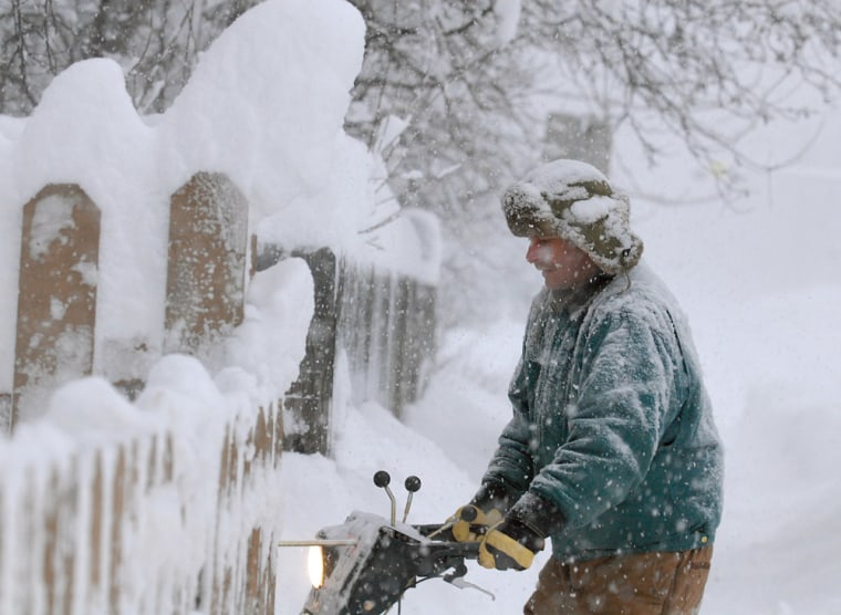 Brent Dunn of Anchorage, Alaska, clears snow outside his home with a snow blower during a winter storm that dumped more than a foot of snow on Jan. 3.