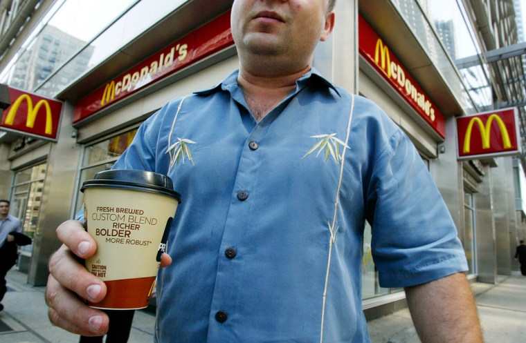 A customer carries a cup of McDonald's premium coffee from a restaurant in downtown Chicago last year. McDonald's has seen strong sales growth during breakfast hours.