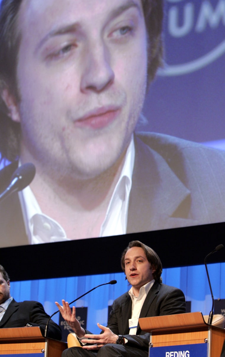 Chad Hurley, the 30-year-old co-founder of YouTube, addresses the World Economic Forum in Switzerland on Saturday with a giant display screen in the background.