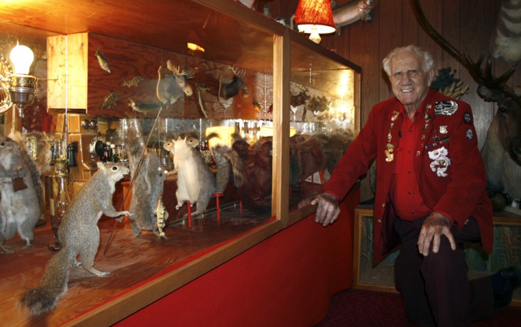 Sam Sanfillippo poses next to a display of stuffed squirrels at the Cress Funeral Home in Madison