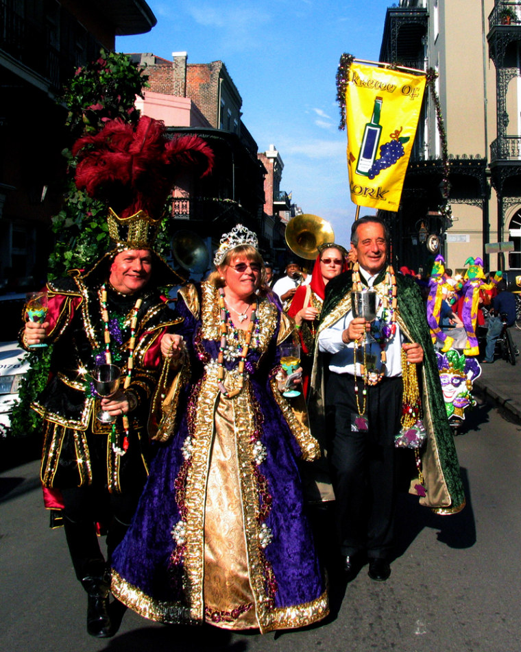 New Orleans Krewe of Cork parades with the King of Cork Patrick Van Hoorebeek, left, 2007 Queen Gillian Pierce, center, and 2007 Grand Marshal Marchese Ferdinando Frescobaldi, right, from Tuscany, Italy, as they toss beads to people in the French Quarter on Royal Street in New Orleans as the start of parades for the 2007 carnival season begins in New Orleans. Mardi Gras Day is Feb. 20.