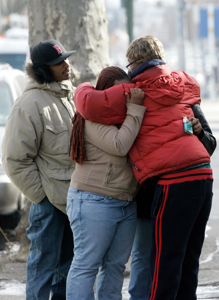 Residents mourn Sunday in West Philadelphia after four children and a woman were killed in a blaze.