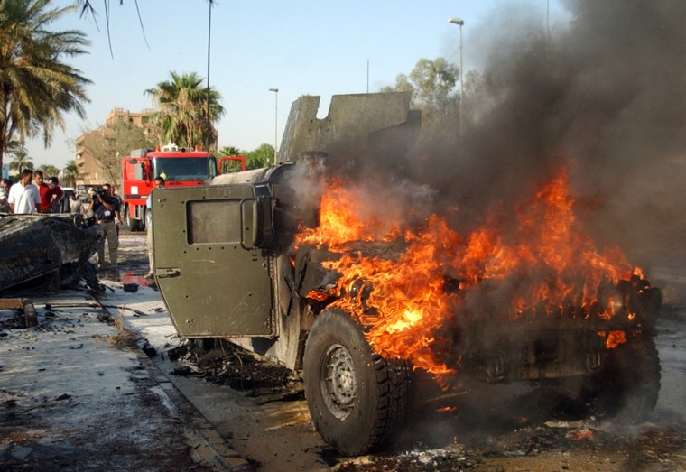 A U.S. military Humvee burns after a car bomb explodes in Baghdad's al-Mansour neighborhood in September 2004. Units have complained that military vehicles lack the armor needed for dangerous missions.