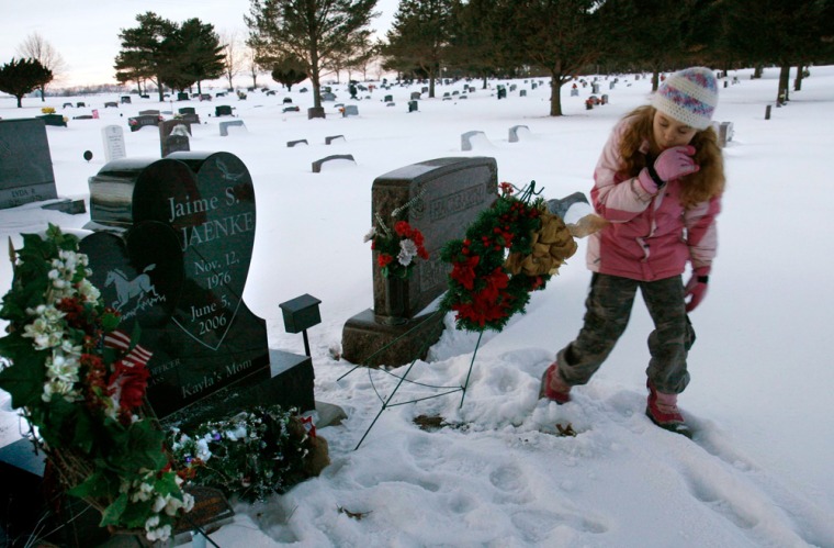 Susan Jaenke's daughter Jaime was killed in Iraq. Jaime had filled out paperwork intending death benefits to go to her mother to take care of Jaime's 9-year-old daughter Kayla, seen at her mother's grave in Alden Cemetery, Iowa. However, grandparents of surviving children are ineligible. 