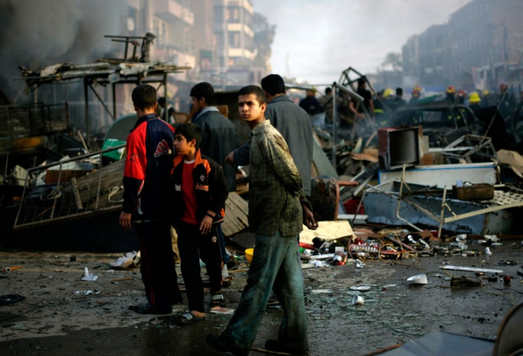 An Iraqi boy walks at a destroyed market after a car bomb explosion in the neighbourhood known as New Baghdad