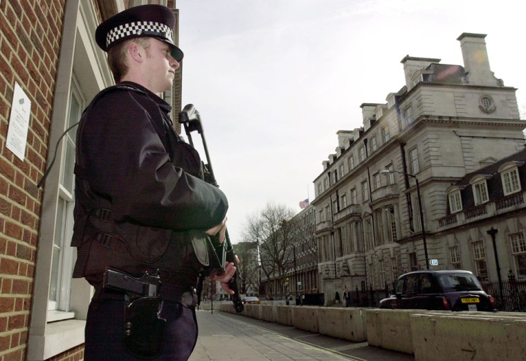 An armed police officer stands guard on a street leading to the U.S. Embassy in London in March 2004 during the aftermath of the Madrid train bombings.