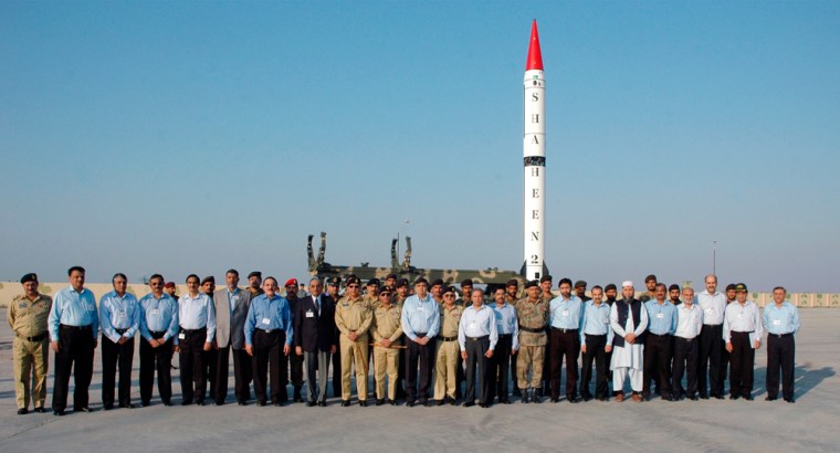 Pakistan's Chairman  of the Joint Chiefs of Staff Committee General Ehsan ul Haq (C) poses for a photograph with scientists and engineers before the launch of the nuclear capable Shaheen II, Hatf-VI missile