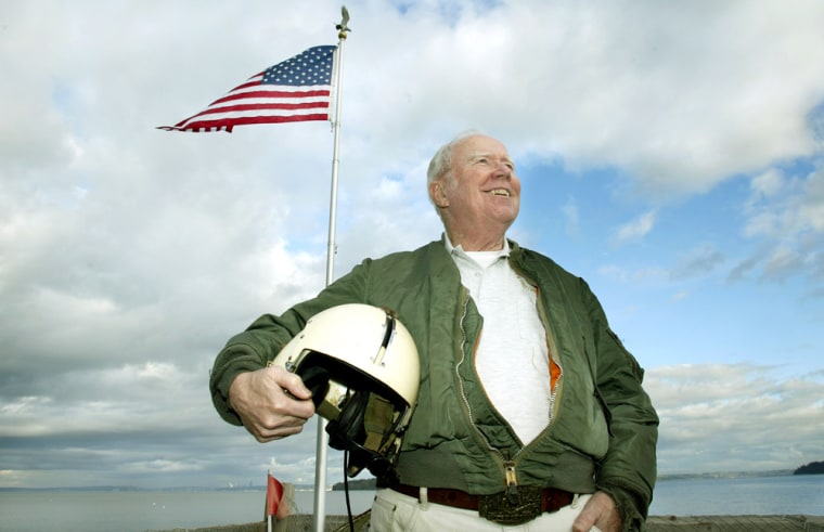 Retired Maj. Bruce Crandall of Manchester, Wash., stands outside his waterfront home with his original flight jacket and helmet on Feb. 14. Crandall, who turns 74 Saturday, is to be awarded the Medal of Honor for his acts Nov. 14, 1965, in Vietnam as a Army chopper pilot. 