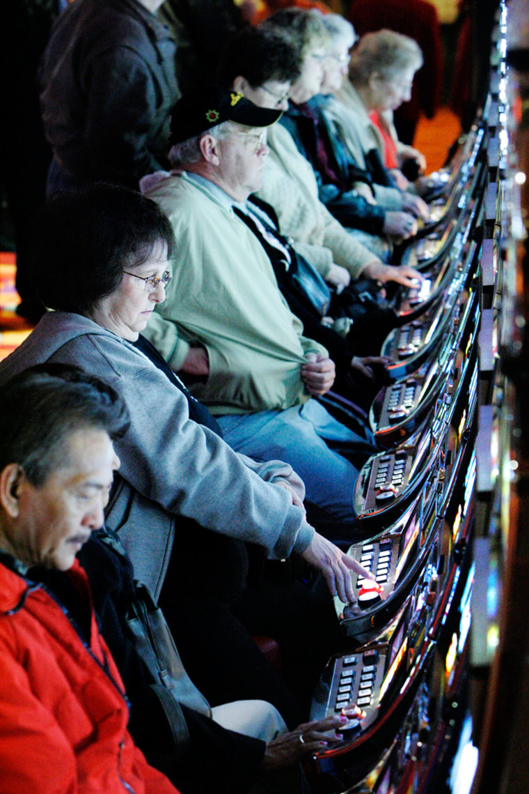 People are seen playing slot-machines at the Philadelphia Park Casino in Bensalem, Pa., near Philadelphia, Tuesday, Dec. 19, 2006.  Philadelphia Park, the home track of champion horse Smarty Jones, on Tuesday opened southeastern Pennsylvania's first slot-machine parlor, a facility expected to compete with the casinos in Atlantic City, N.J. (AP Photo/Matt Rourke)