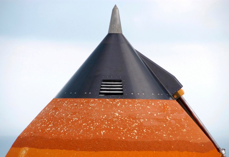 The top of the external tank attached to space shuttle Atlantis shows damage caused by hail n Cape Canaveral