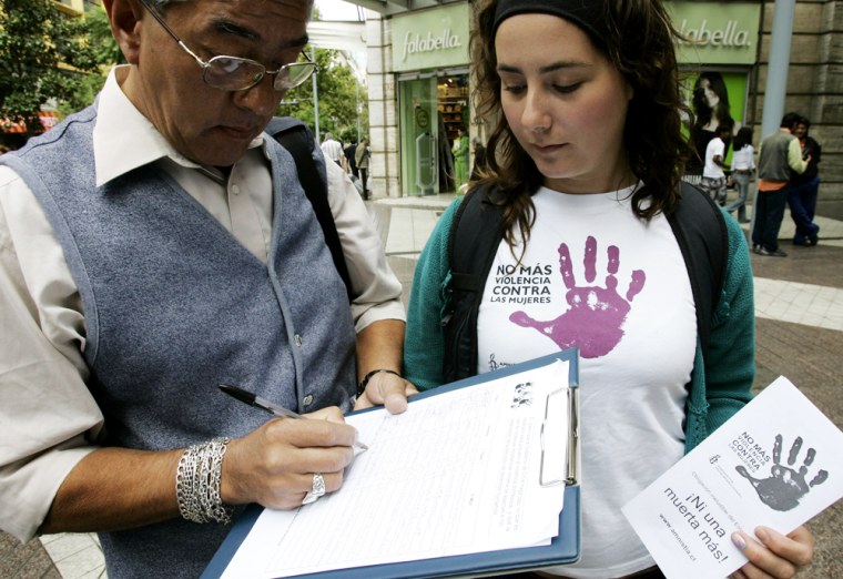 A woman collects signatures for a campaign against domestic violence in Santiago, Chile, on Feb. 20. Michelle Bachelet, Chile's first female President, is making tangible strides toward improving the status of women, increasing their role in politics, giving them the right to breast-feed in the workplace and offering them greater protection against domestic violence.
