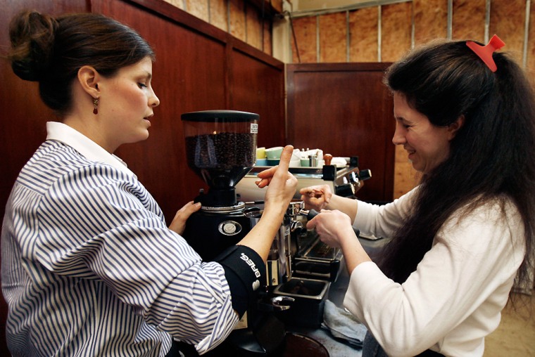 ** ADVANCE WEEKEND MARCH 10-11 ** At a coffee training session at Zoka Coffee in Seattle Lindsey Elliott, left, shows Heather Pluska proper technique to load an espresso machine on Feb. 11, 2007. Zoka is one of several specialty coffee roasters in Seattle that hold regular training sessions for their wholesale customers _ including espresso bars, restaurants, and bakeries _ on how to make a high-end espresso drink.     (AP Photo/Jeff Reinking)