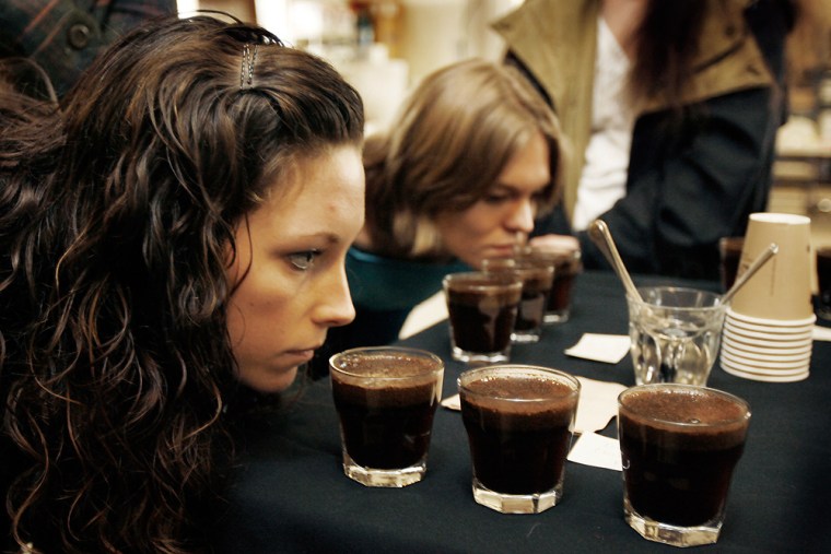 At a coffee training session at Zoka Coffee in Seattle Randi Baker, left, and Liz Foster smell coffee at a sipping table.