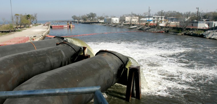 Pumps put in place by the Army Corps of Engineers move water from New Orleans' 17th Street Canal to Lake Pontchartra in New Orleans. The contract to install the pumps has come under fire.