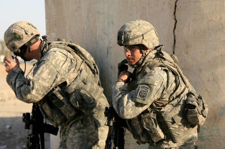 Sgt. Andrew Simpson, 24, from York, Pa., left, and Pfc. Salvador Gutierrez, 21, from Oxnard, Calif., both of the 82nd Airborne Division stand watch Wednesday after hearing gunshots in the Hurriyah neighborhood of Baghdad. The soldiers are beneficiaries of a recent decline in sectarian killings.