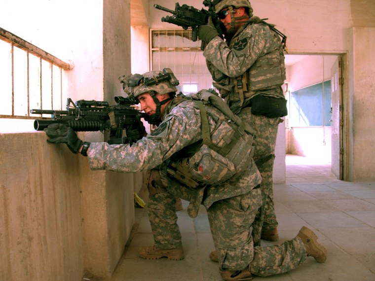 Spc. Jeremiah Westerfeld, left, 22, from Batesville, Indiana, and Sgt. William Rose , 26, from Arlington, Mass., stake out firing positions in an abandoned school in Baqouba on Wednesday, March 14, 2007. They are members of the US Army's 5th Battalion, 20th Infantry Regiment, 3rd Brigade, 2nd Infantry Division, who faced fierce battles on their first day of patrols in Diyala province northeast of Baghdad, where they were sent to quell burgeoning violence on the \"belts\" of Baghdad.  (AP Photo/Lauren Frayer)