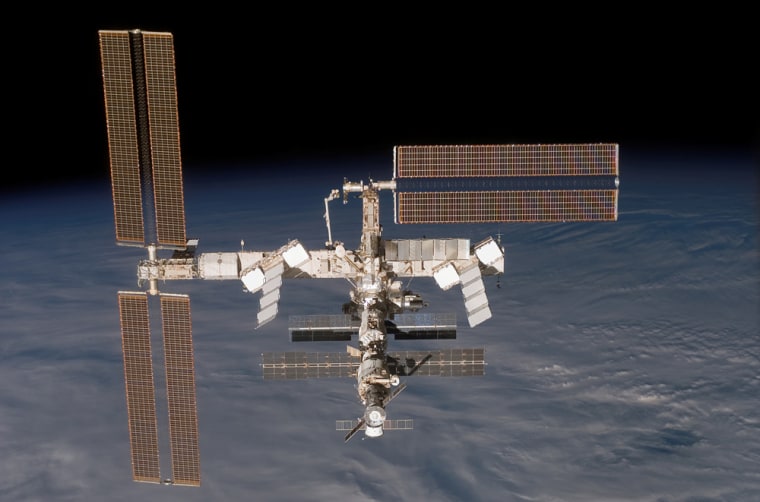 The international space station, shown here in a December picture taken from the shuttle Discovery, gradually loses altitude due to atmospheric drag. The Progress cargo craft at the bottom of the station's stack provides some capability to reboost the orbit.