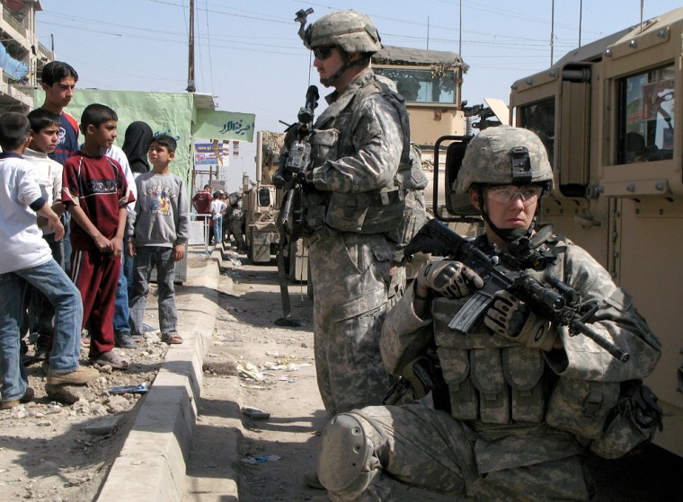 U.S. army soldiers from the 82nd Airborne Division stand guard next to a Humvee in Baghdad's Shiite enclave of Sadr City, Iraq, on Tuesday. 