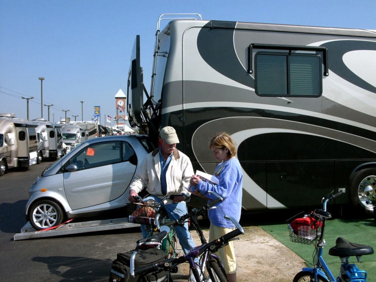 Visitors at the Family Motor Coach Association's convention in Perry, Ga. check out the amenities of one RV — including the Mercedes Smart Car in the rear. RV sales have risen the last five years.