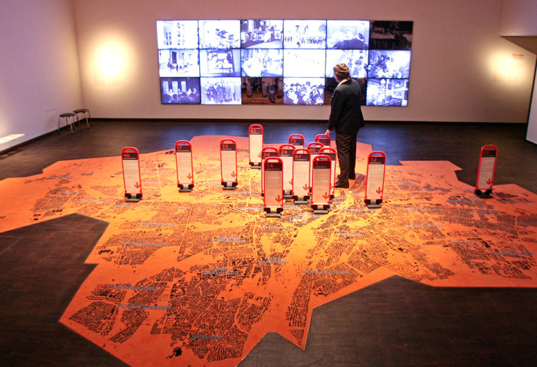 A woman stands on a huge city map  inside an installation during the presentation of the new Jewish Museum in Munich, southern Germany on Wednesday, March 21, 2007. Just blocks from where Joseph Goebbels ordered the destruction of Munich's main synagogue on Kristallnacht, the city is opening a $18 million (13.5 million) museum dedicated to the heritage and the future of its growing Jewish community.(AP Photo/Uwe Lein)