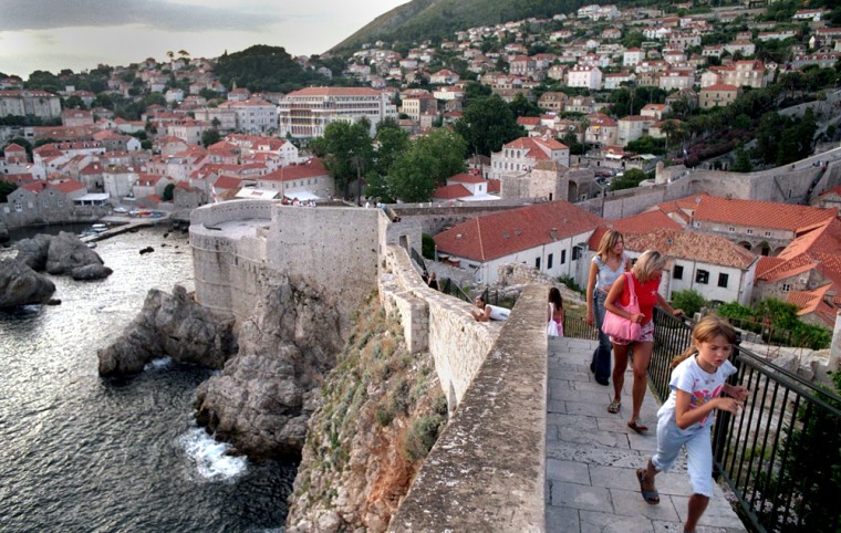 Tourists walk on the city wall that surrounds the historic town of Dubrovnik, Croatia. While the number of Americans visiting places like Croatia is still relatively small, growth is strong. AAA's bookings to Croatia increased an astounding 440 percent this year over last. 