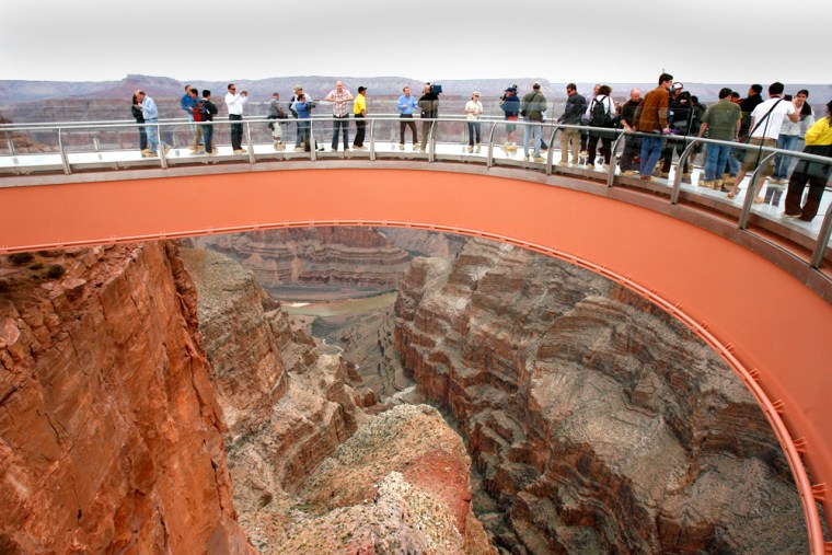 People walk on the Skywalk during the First Walk event at the Grand Canyon on the Hualapai Indian Reservation earlier this month at Grand Canyon West, Ariz.