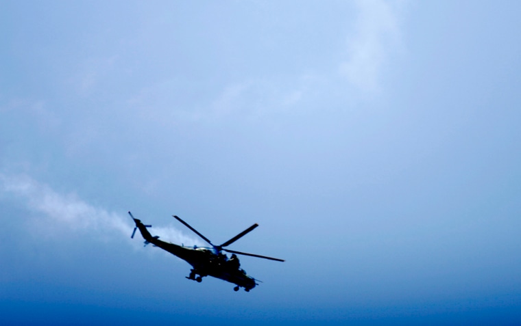 An Ethiopian military helicopter hit by insurgents is seen in the skies above Mogadishu