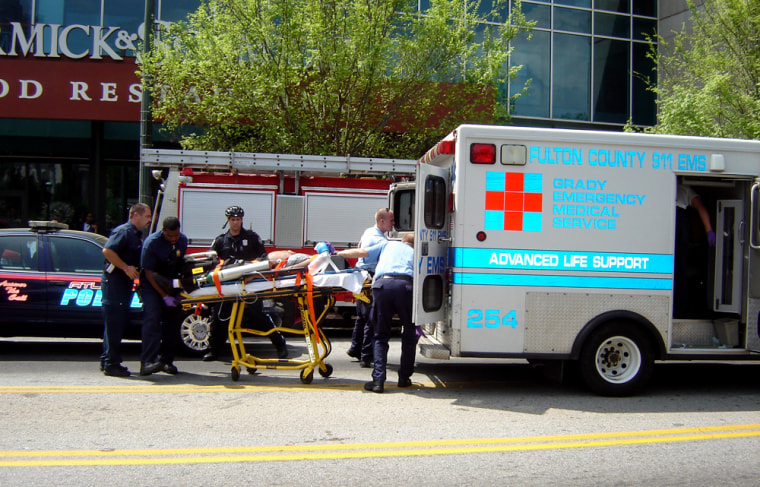 Rescue workers transport a victim from the CNN complex in Atlanta on Tuesday. A witness reported hearing four or five shots fired in the complex.