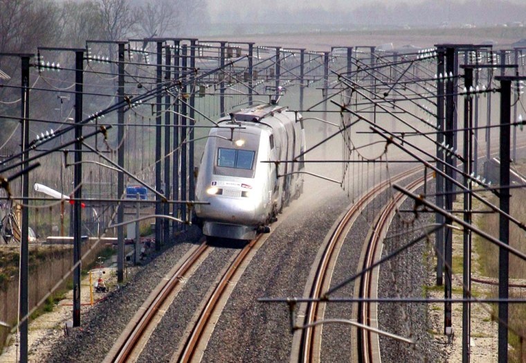 The high-speed French train, with a souped-up engine and wheels, enters the world speed record registering zone shortly before breaking the world speed record near Grigny, eastern France, Tuesday, April 3, 2007, reaching 574.8 kph (357.2 mph). The black and chrome train with three double-decker cars, named the V150, bettered the previous record of 515.3 (320.2 mph), set in 1990 by the French fast train. However, it fell short of the ultimate record set by Japan's non-conventional magnetically levitated train, which sped to 581 kph (361 mph) in 2003. (AP Photo/Francois Mori)