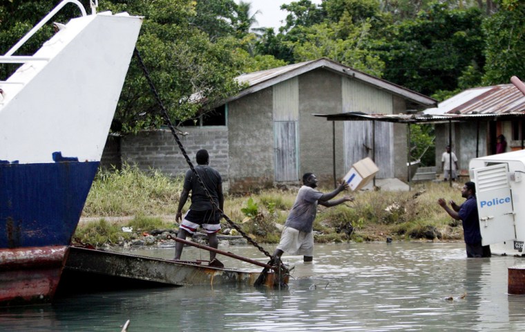 Workers in the town of Munda on Wednesday load Red Cross relief supplies onto a boat bound for the island of Gizo, reported to be one of the worst hit by Monday's earthquake and tsunami. 