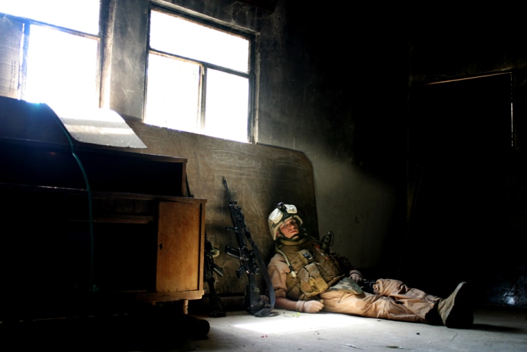 A Marine with the 2nd Platoon, E Company, 2nd Battalion, 7th Marines, pauses for some rest in a building during Operation Zaidon II on March 22 in Zaidon, Iraq. 