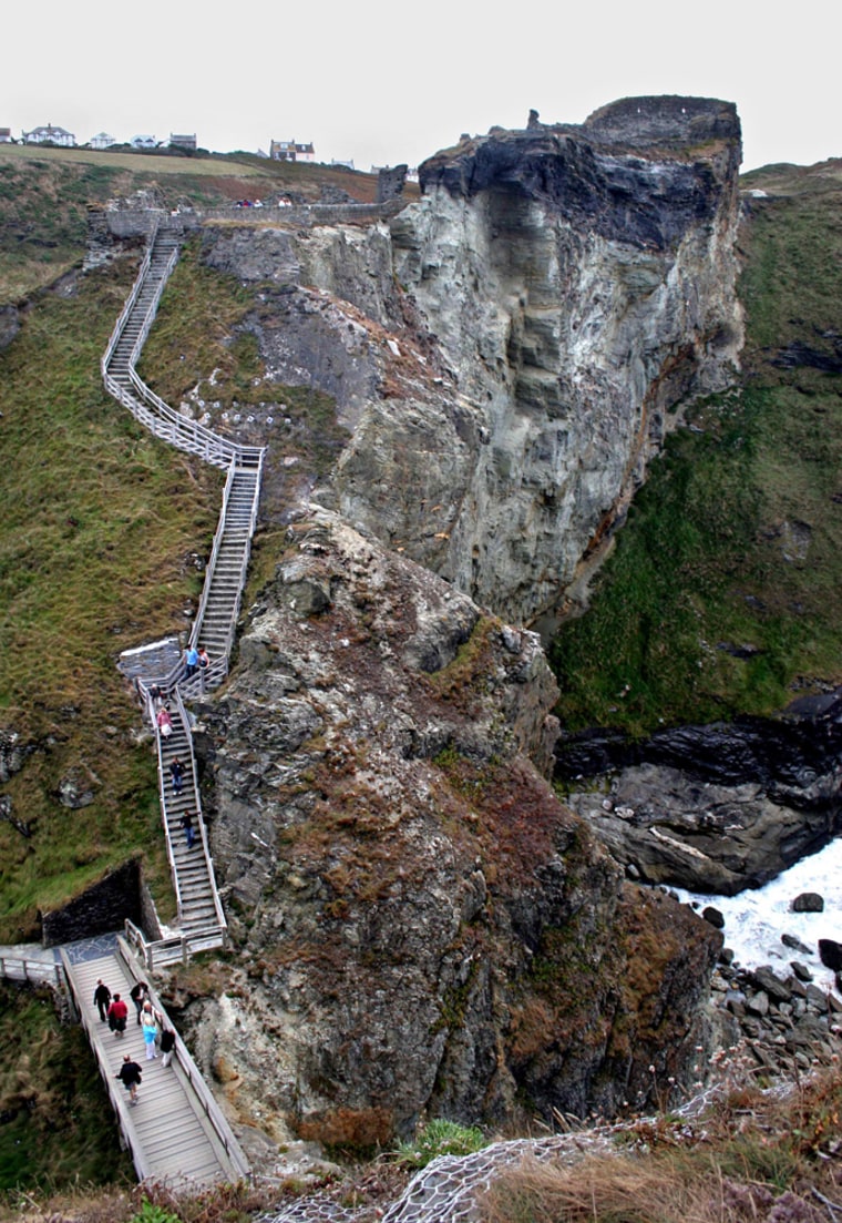 Tourists explore the grounds of Tintagel Castle in southwestern England. 
