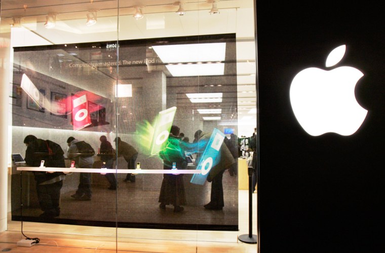 Customers shop inside an Apple Store in Cambridge, Mass., earlier this year. Apple Inc. said Monday it has sold 100 million iPod media players.