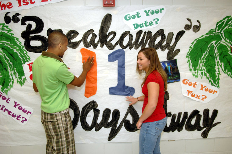 Senior Class President James Hall, left, and Senior Class Secretary Christin Lord update a prom countdown sign at Turner County High School in Ashburn, Ga., Tuesday, April 10.