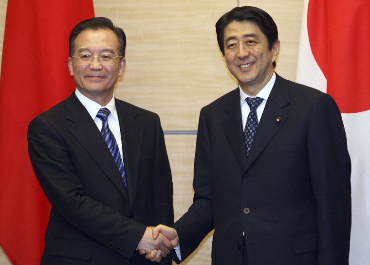 Chinese Premier Wen and Japanese PM Abe shake hands following the China-Japan joint declaration signing ceremony in Tokyo