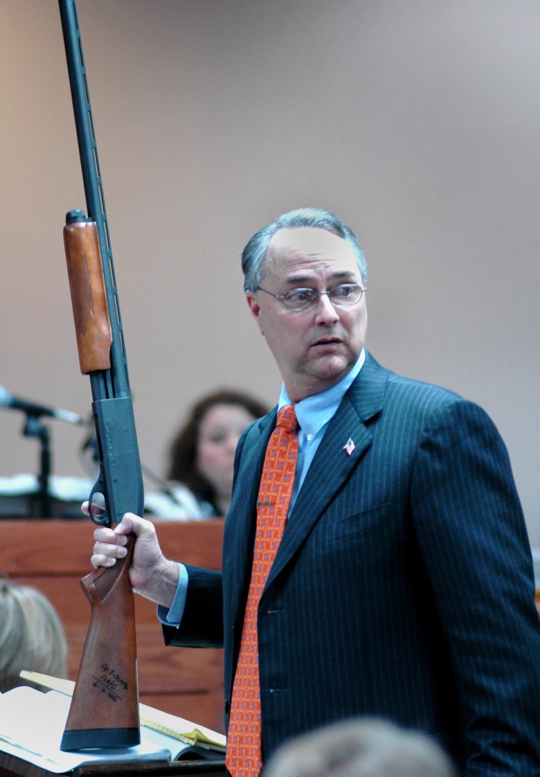 Defense attorney Steve Farese uses a shotgun to make a point Friday at Mary Winkler's murder trial in Selmer, Tenn.