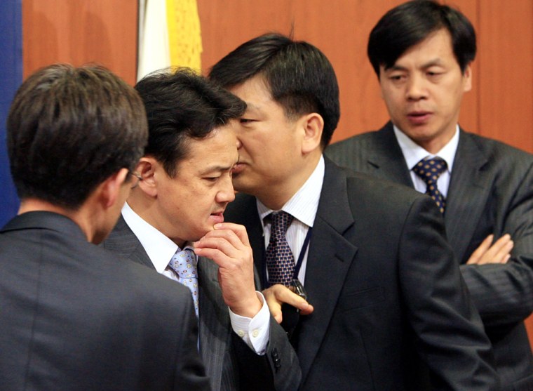 South Korean Foreign Ministry officials confer Tuesday at their office in Seoul. 