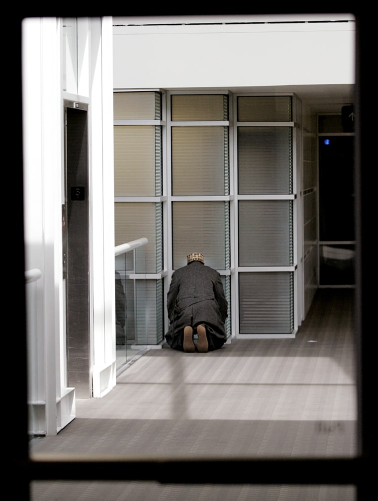 A Muslim cab driver takes time for afternoon prayers outside the meeting room at the Minneapolis-St. Paul International Airport in Minneapolis. Taxi drivers who refuse service to travelers carrying alcohol at the Minneapolis-St. Paul International Airport face tougher penalties despite protests from Muslims cabbies who sought a compromise for religious reasons, officials said Monday.