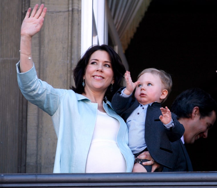 Prince Christian, second in line to the Danish throne, waves to crowds gathered below in the arms of his mother, Australian-born Crown Princess Mary on April 16 from the balcony of Amalienborg Palace in Copenhagen, Denmark. 