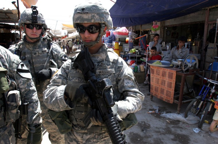 U.S. troops patrol a market in Abu Ghraib district of Baghdad, Iraq, on Thursday.
