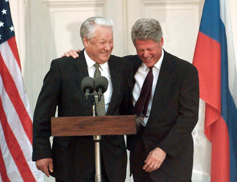 (FILES) US President Clinton (R) laughs
