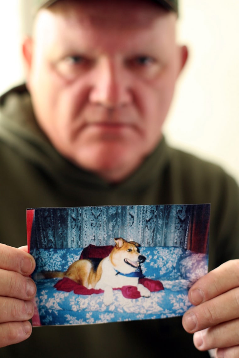 Larry Klimes holds a photo of his dog, Joey, at his Wendell, Idaho home on April 21. Klimes' dog died after eating tainted dog food.