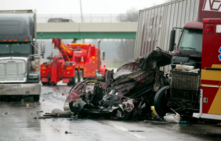 Wreckage from a deadly highway pileup sits on a rainy stretch of the Indiana Toll Road near Bristol, Ind.