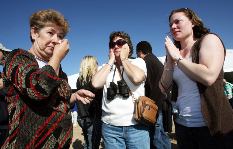 Jennifer Gorman, left, the widow of David B. Gorman, who died on August, 16, 2005, reacts after his ashes were launched into space aboard a rocket Saturday, April, 28, 2007, from Spaceport America, in Upham, N.M.  Gorman's sister Marilyn Larson, center, and niece Eileen Whitesides, right, also attended the launch.   (AP Photo/Mark Lambie)