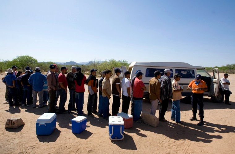 A group of migrants wait in line to give their names to a member of Mexico's government sponsored migrant assistance group, \"Grupo Beta\" in the Mexican town of El Tortugo, near the border with Arizona, Wednesday April 11, 2007. Mexican druglords, fighting back against increased U.S. border security, have seized control of coveted migrant-smuggling routes, collecting money and distracting National Guard and Border Patrol agents, Mexican and U.S. officials say.     (AP Photo/Eduardo Verdugo)